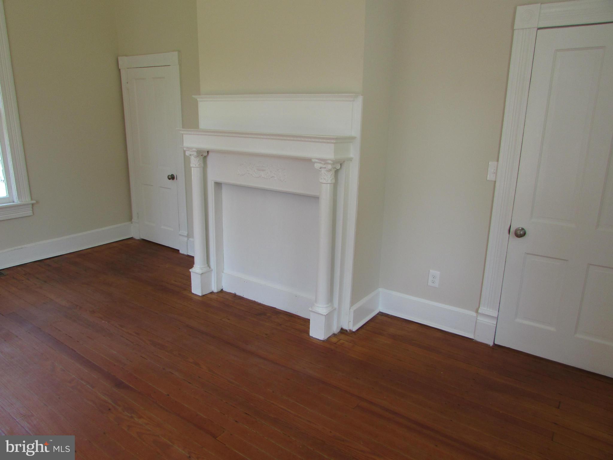 9520 Main Street Manassas, VA 20110 - Photo 10 of 19 a view of an empty room with wooden floor and a window