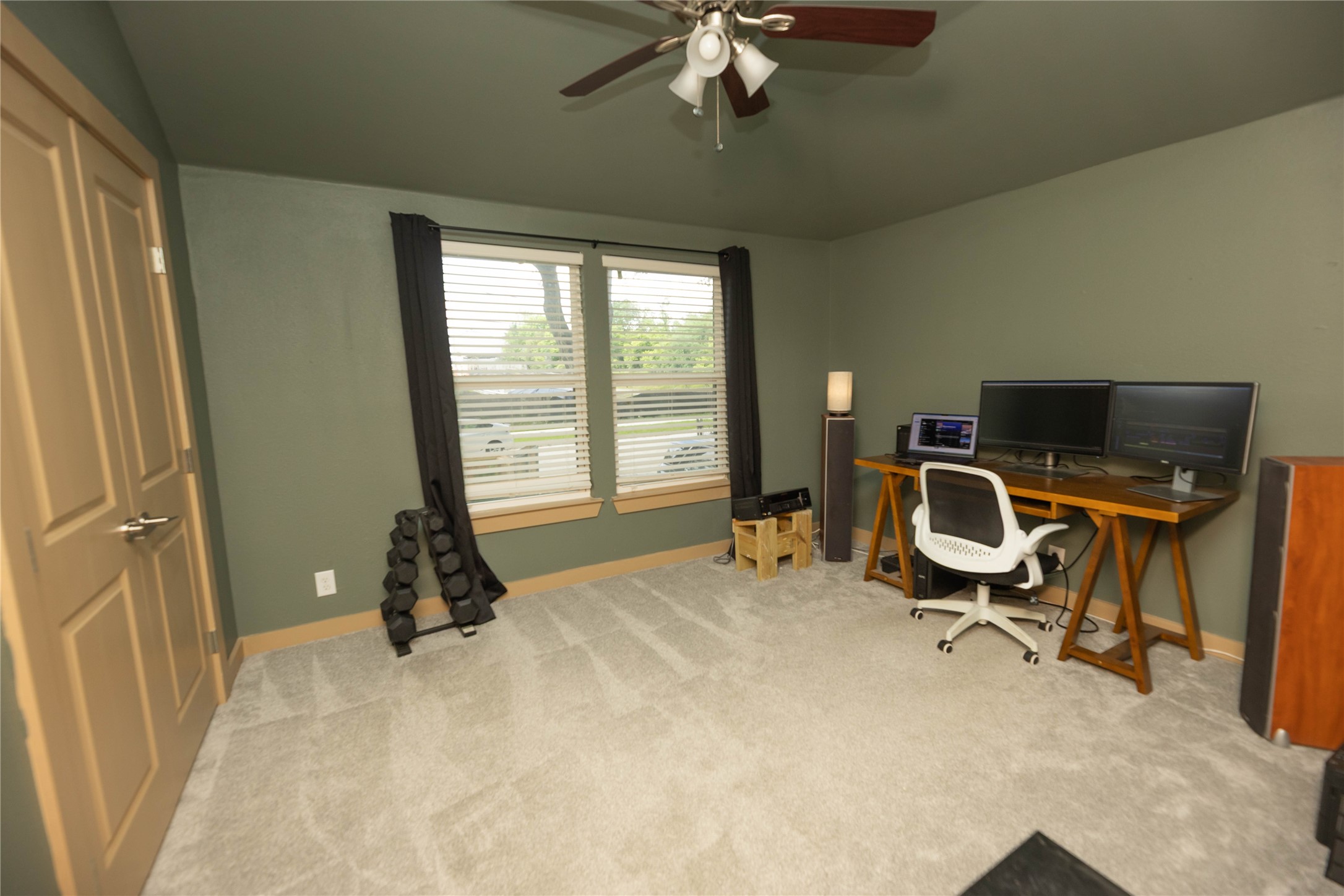8007 Capitol Street Houston, TX 77012 - Photo 19 of 25 This room includes a large window for natural light, neutral walls, and carpeted flooring. It features a ceiling fan.
