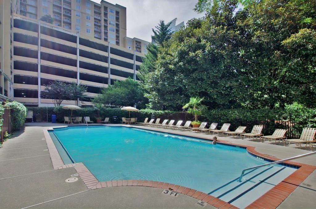 1101 Juniper Street Northeast, Unit 1416 Atlanta, GA 30309 - Photo 16 of 48 a view of a swimming pool with a patio and plants