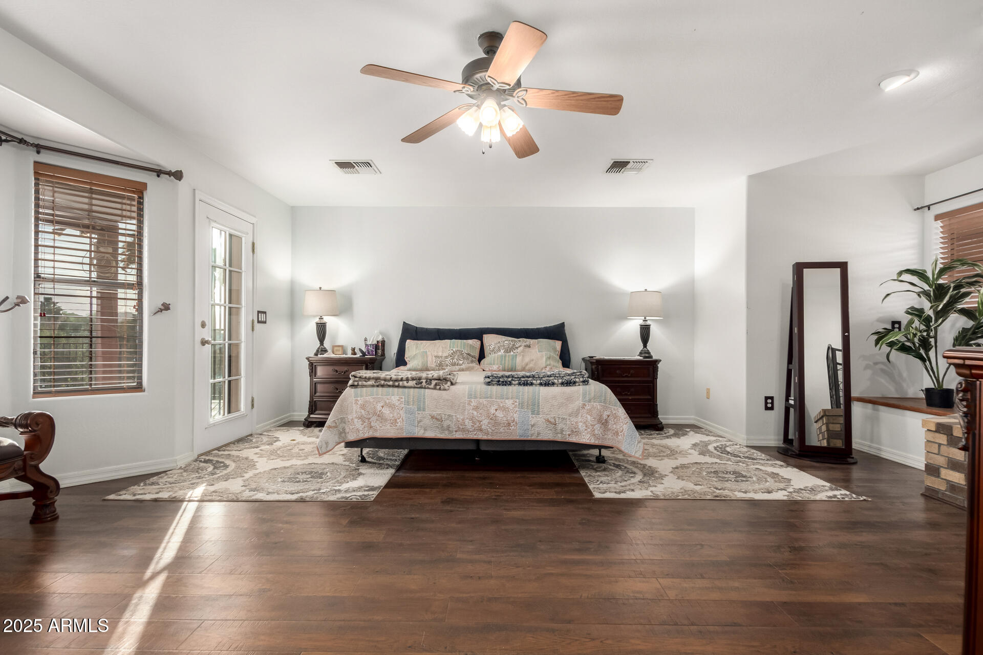 17645 East Stacey Road Queen Creek, AZ 85142 - Photo 26 of 109 a spacious bedroom with a bed and a chandelier