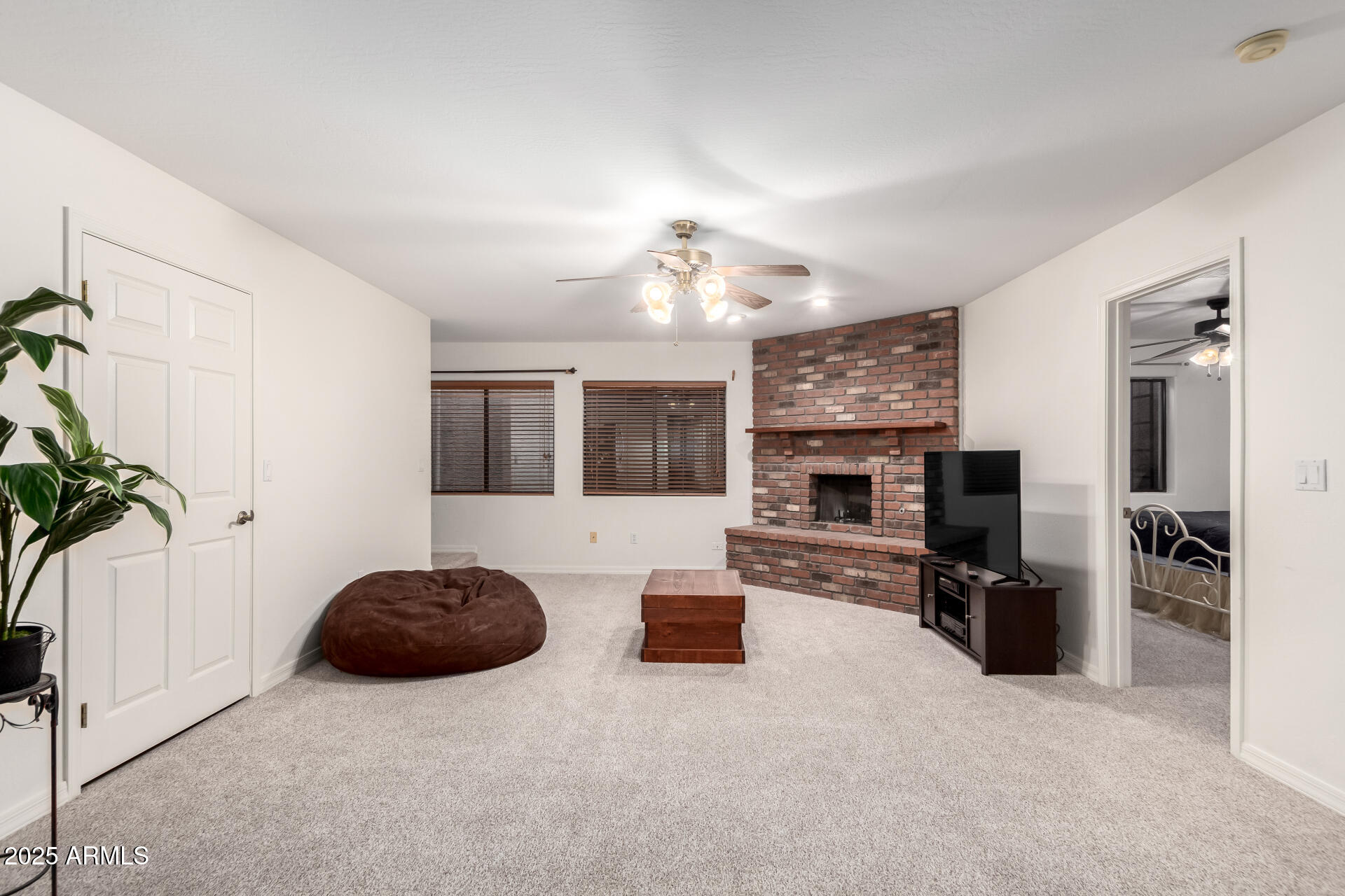 17645 East Stacey Road Queen Creek, AZ 85142 - Photo 48 of 109 a living room with furniture a fireplace and a flat screen tv