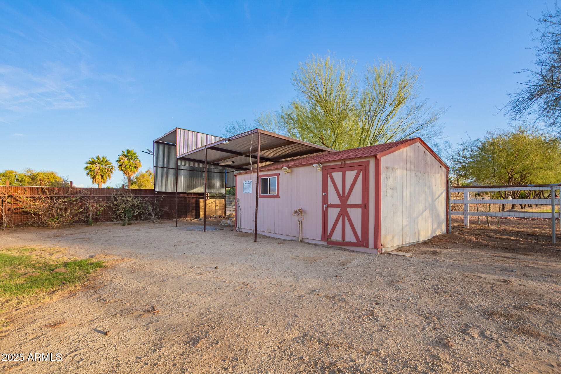 17645 East Stacey Road Queen Creek, AZ 85142 - Photo 90 of 109 a view of a barn with a table and chairs under an umbrella