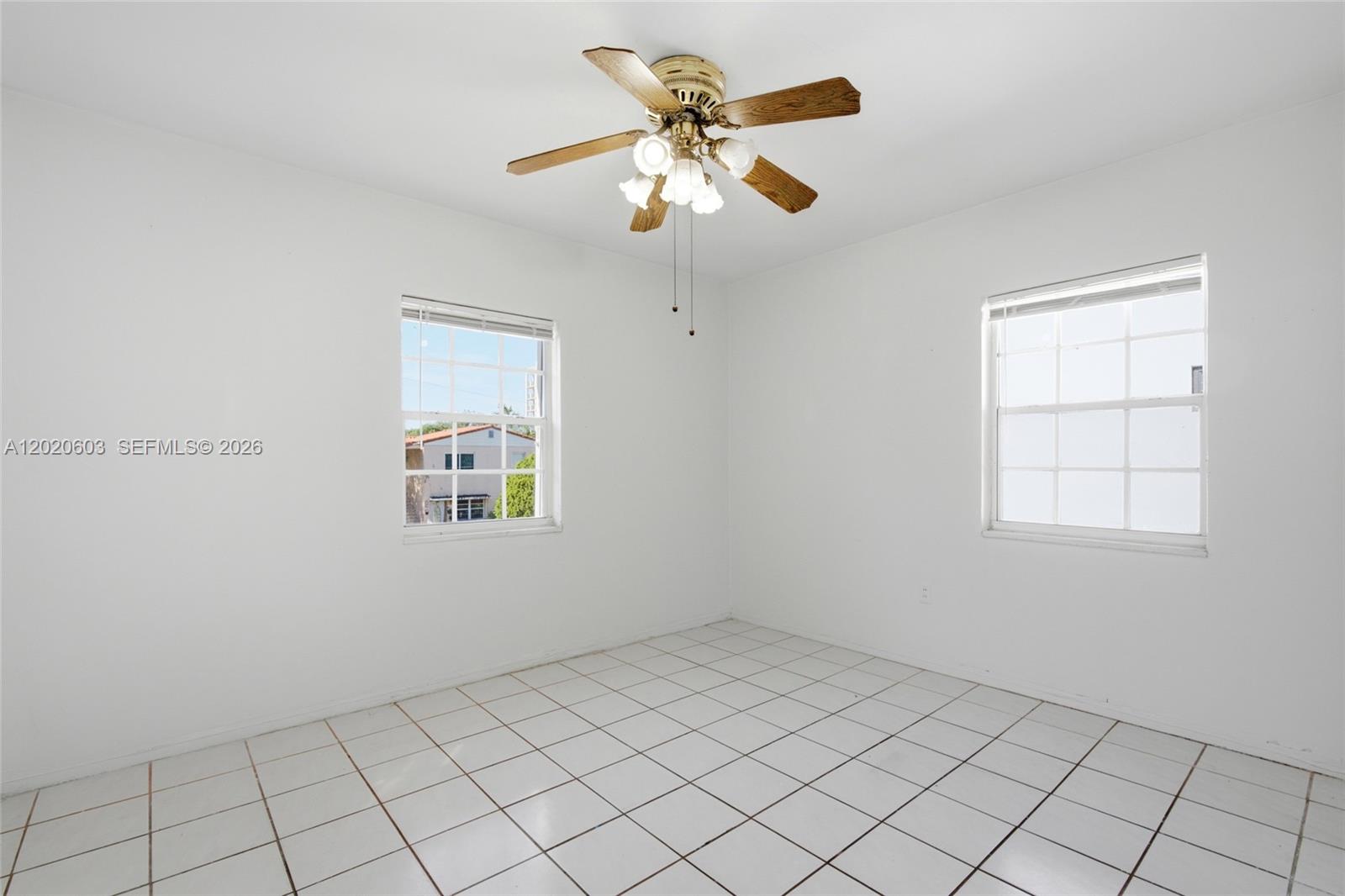 3750 Southwest 27th Street Miami, FL 33134 - Photo 23 of 41 an empty room with windows and ceiling fan