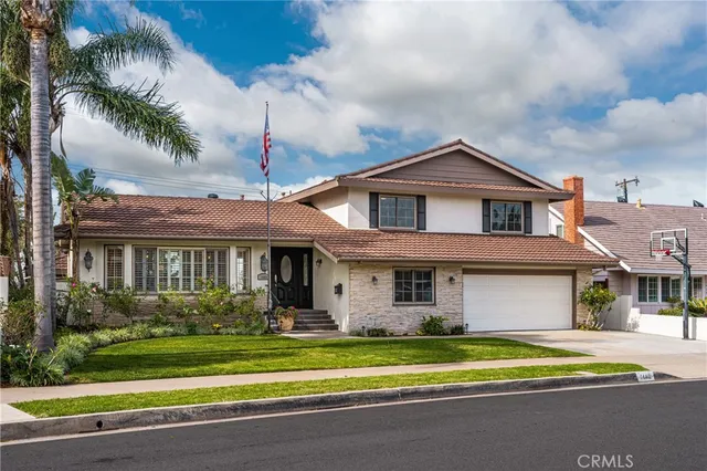 a front view of a house with a yard table and chairs