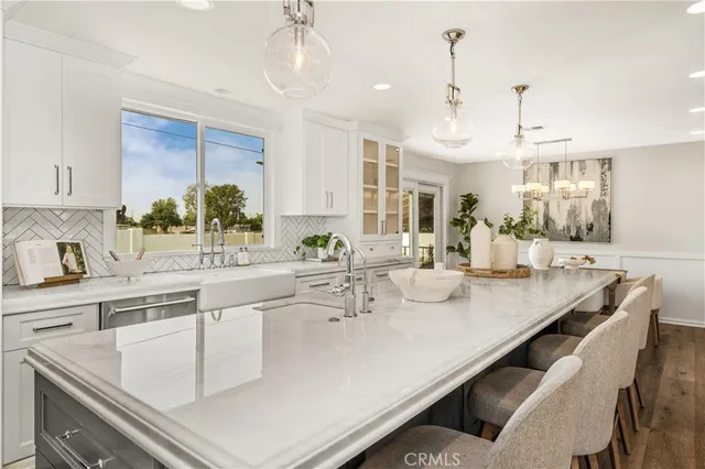 a kitchen with a sink a center island and cabinets