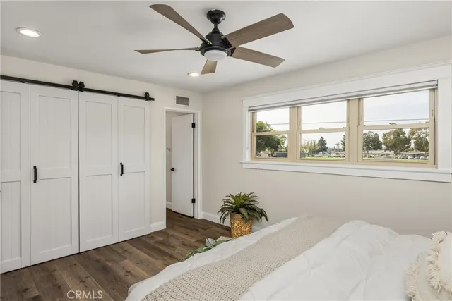 a bedroom with a large bed and a window