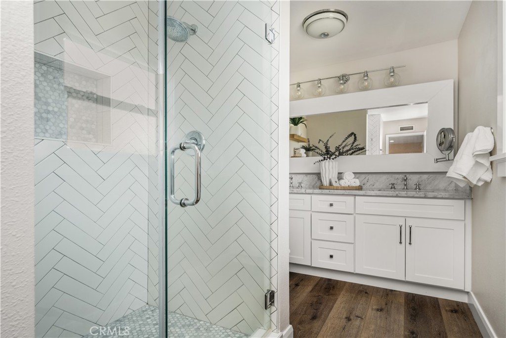1440 North Harding Street Orange, CA 92867 - Photo 22 of 38 a bathroom with a granite countertop shower sink and mirror