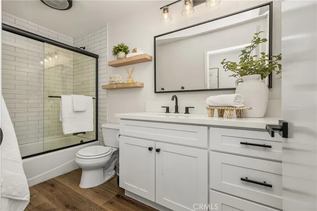 a bathroom with a sink mirror vanity and toilet