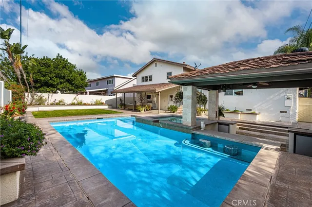 a view of a house with swimming pool and sitting area