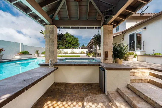 a kitchen with sink and view of living room