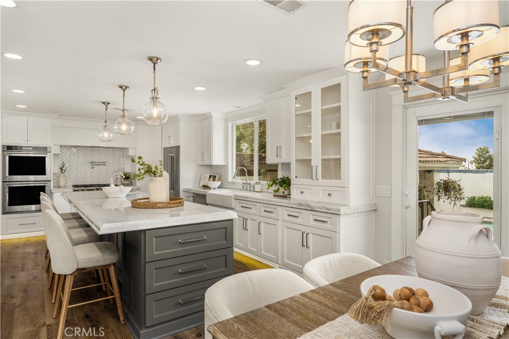 1440 North Harding Street Orange, CA 92867 - Photo 9 of 38 a kitchen with a table chairs stove and cabinets