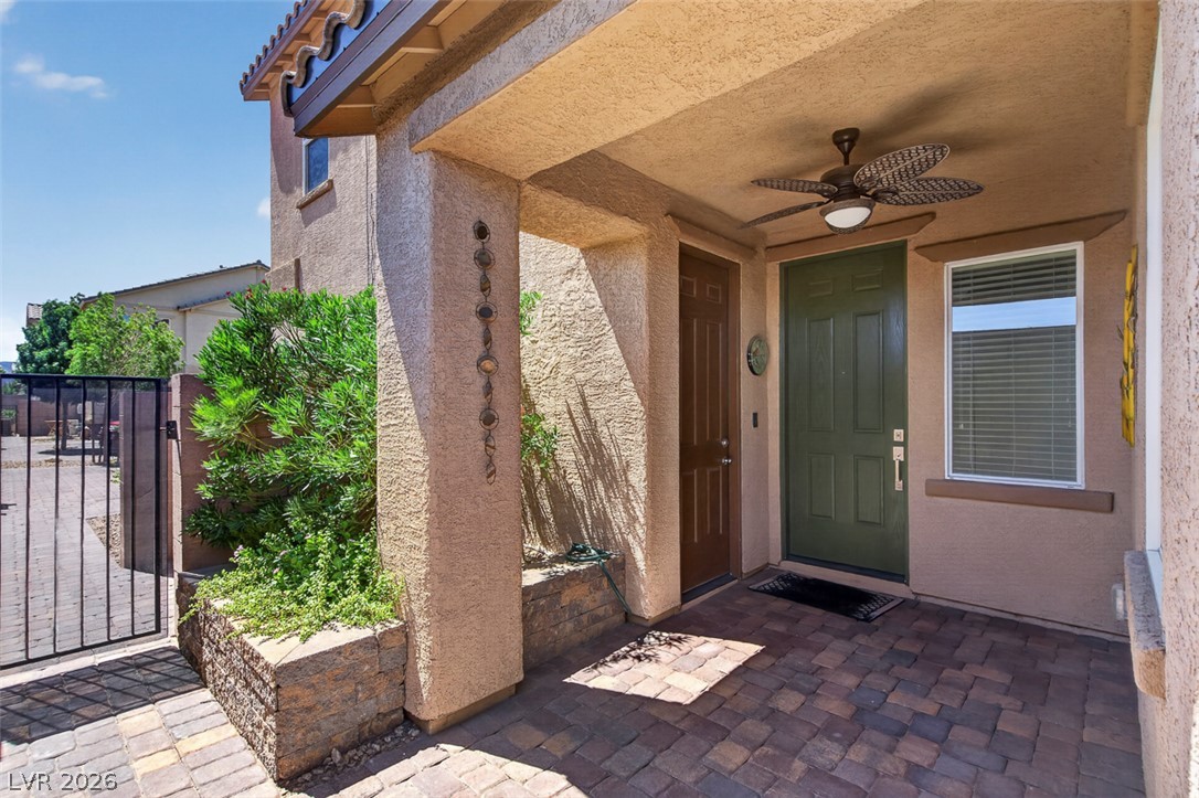 1824 Redland Ridge Street Henderson, NV 89002 - Photo 21 of 69 A welcoming entry features a paver patio and a stylish overhead fan, enhancing outdoor comfort.