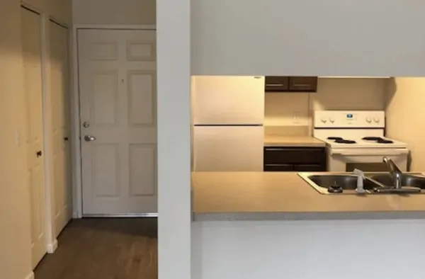 a kitchen with a refrigerator and a stove