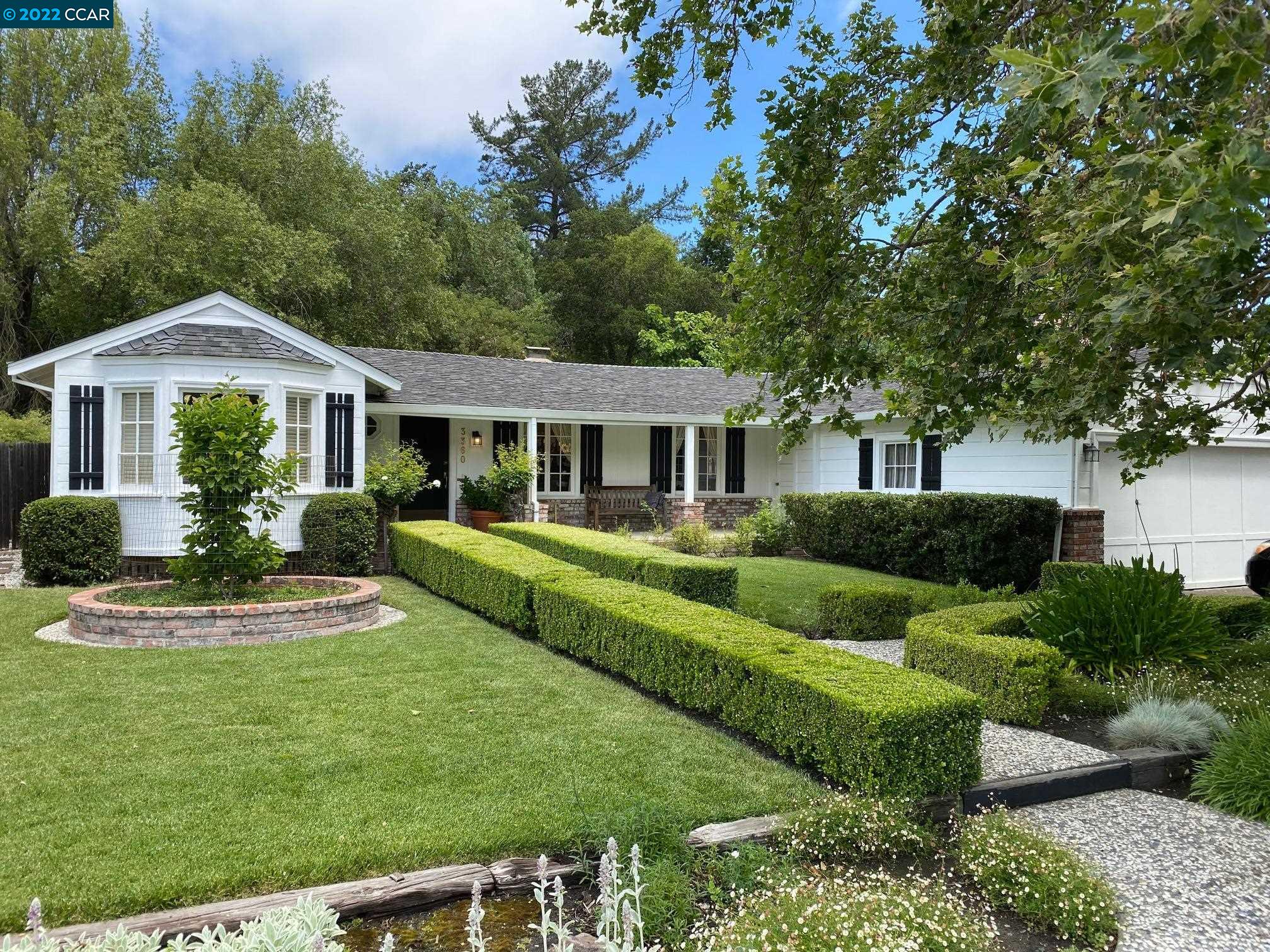 a front view of a house with a yard table and chairs