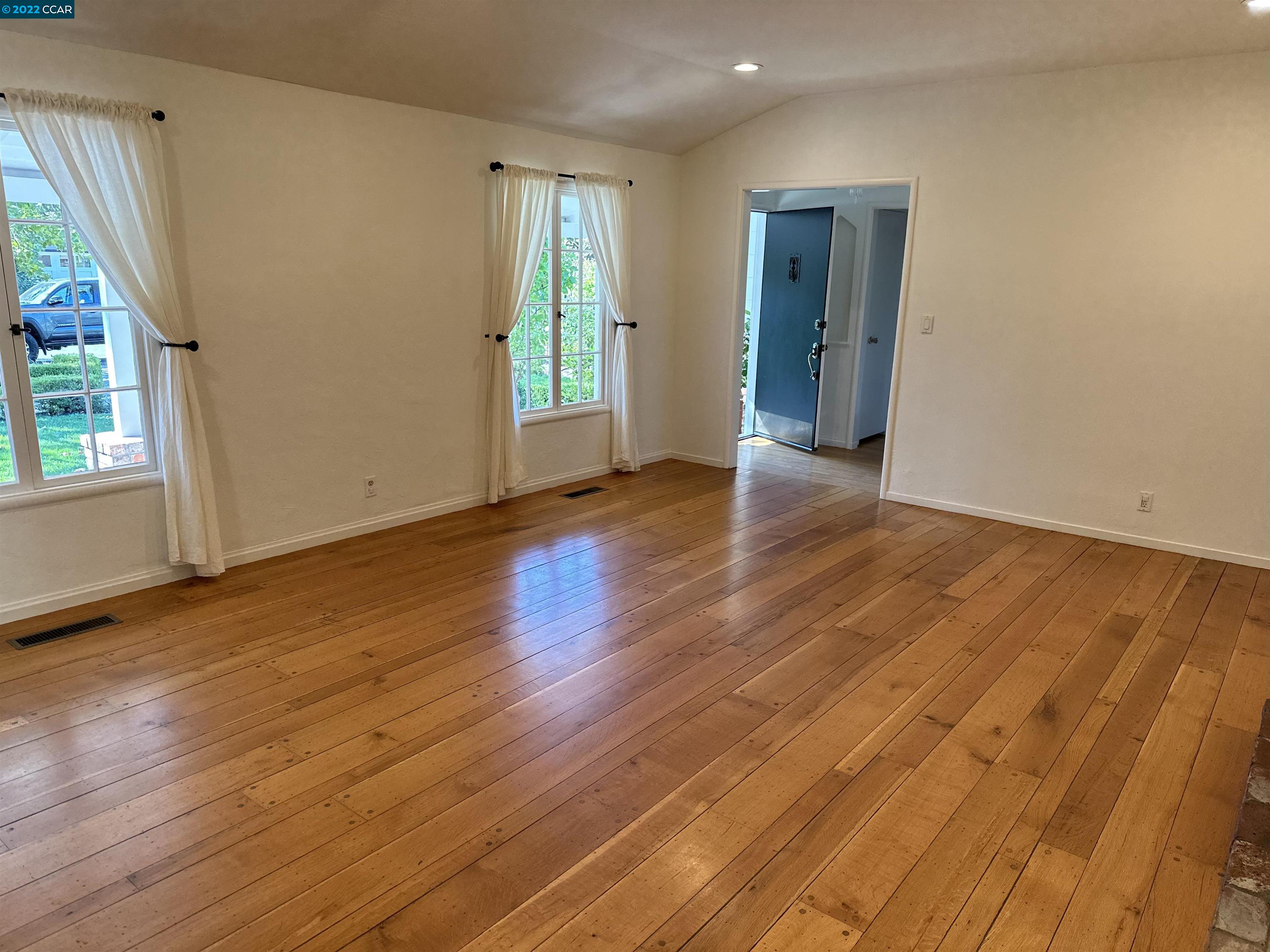 3360 Victoria Avenue Lafayette, CA 94549 - Photo 16 of 20 an empty room with wooden floor and windows