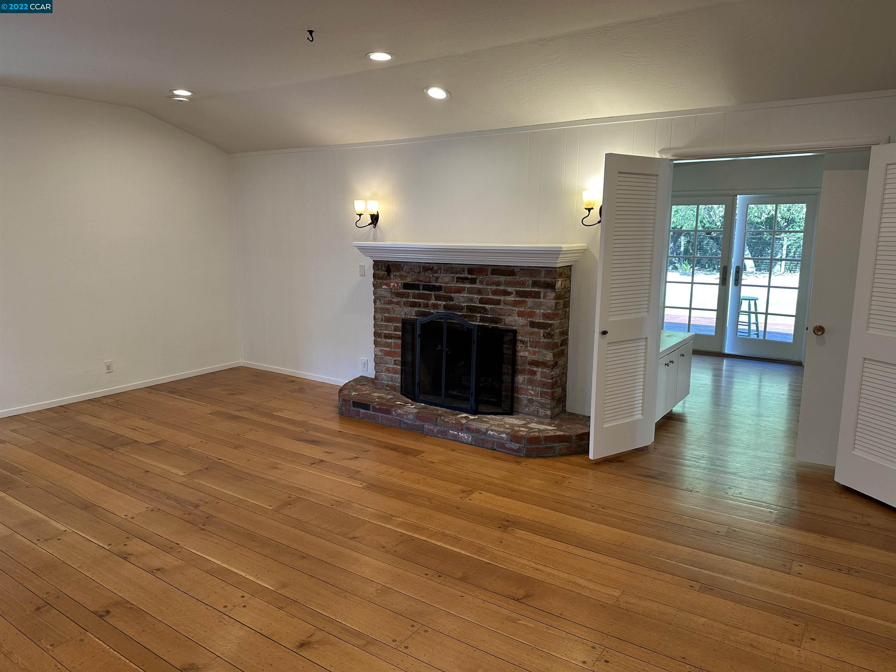 3360 Victoria Avenue Lafayette, CA 94549 - Photo 17 of 20 a view of empty room with wooden floor and fireplace