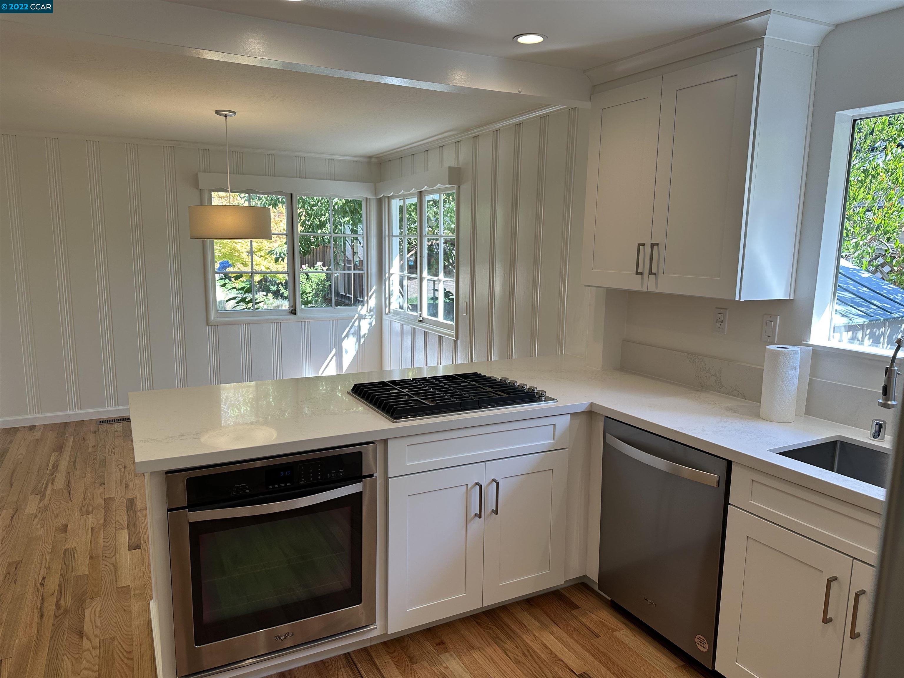 3360 Victoria Avenue Lafayette, CA 94549 - Photo 18 of 20 a kitchen with granite countertop a stove a sink and a microwave