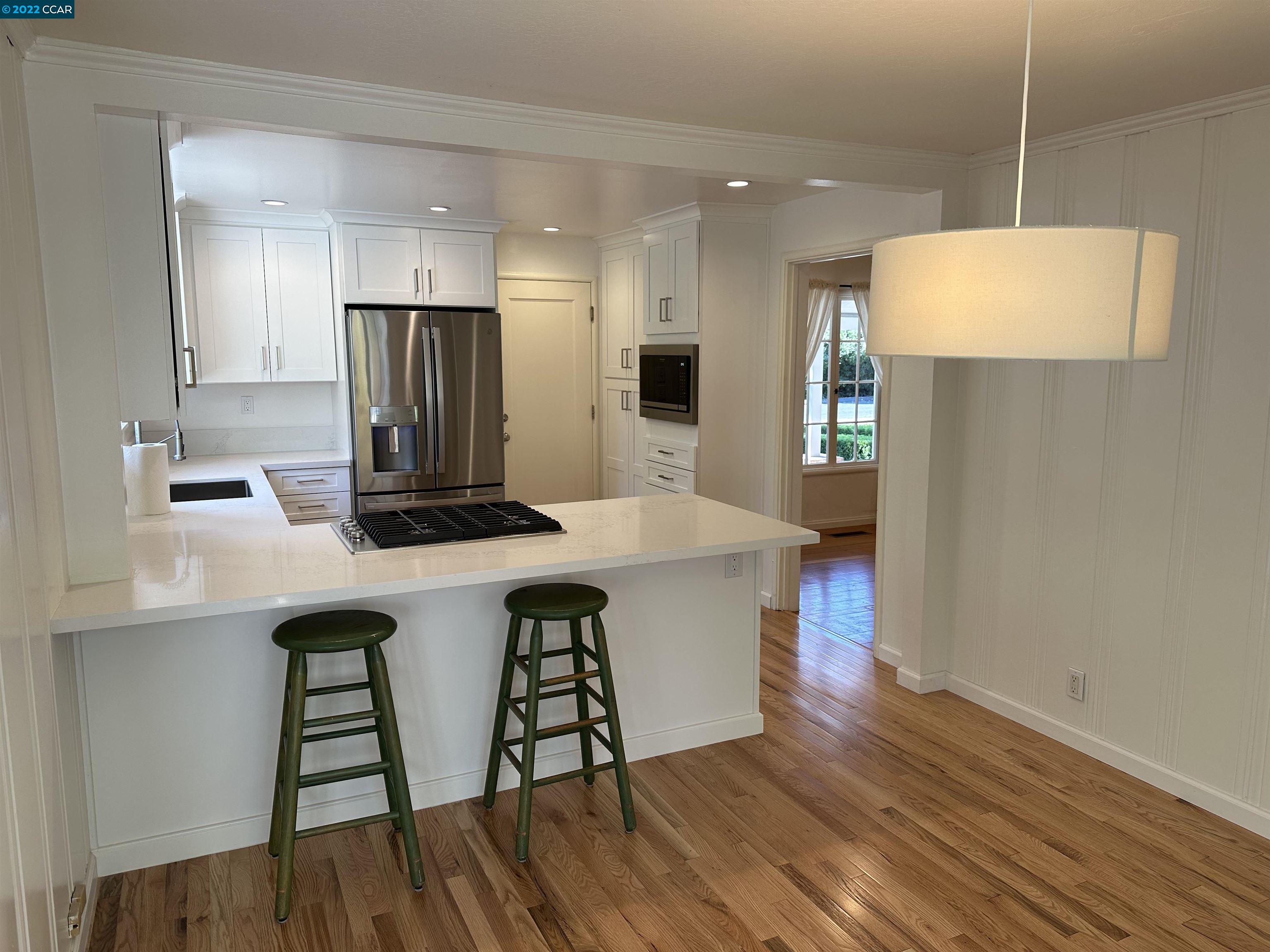 3360 Victoria Avenue Lafayette, CA 94549 - Photo 20 of 20 a kitchen with a table chairs refrigerator and microwave