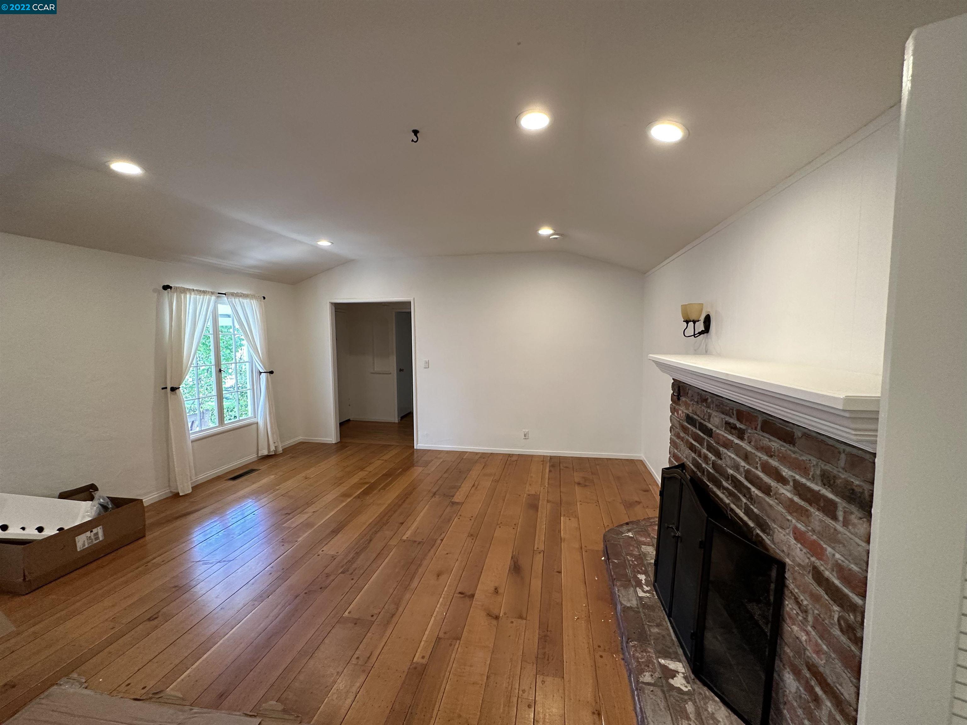 3360 Victoria Avenue Lafayette, CA 94549 - Photo 9 of 20 a view of empty room with wooden floor and fireplace