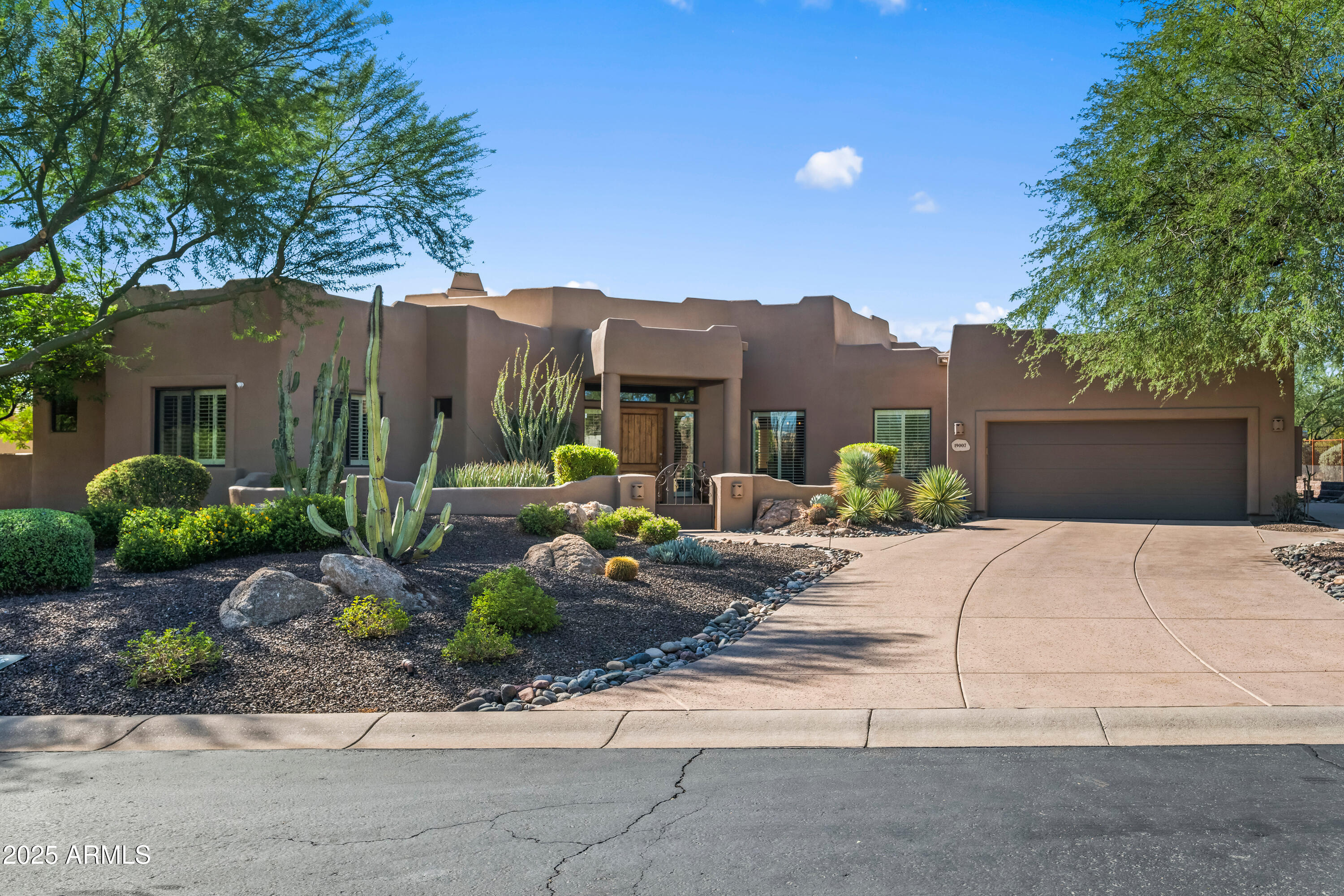 19007 East Lazo Court Rio Verde, AZ 85263 - Photo 4 of 58 a view of a house with a garden and pathway