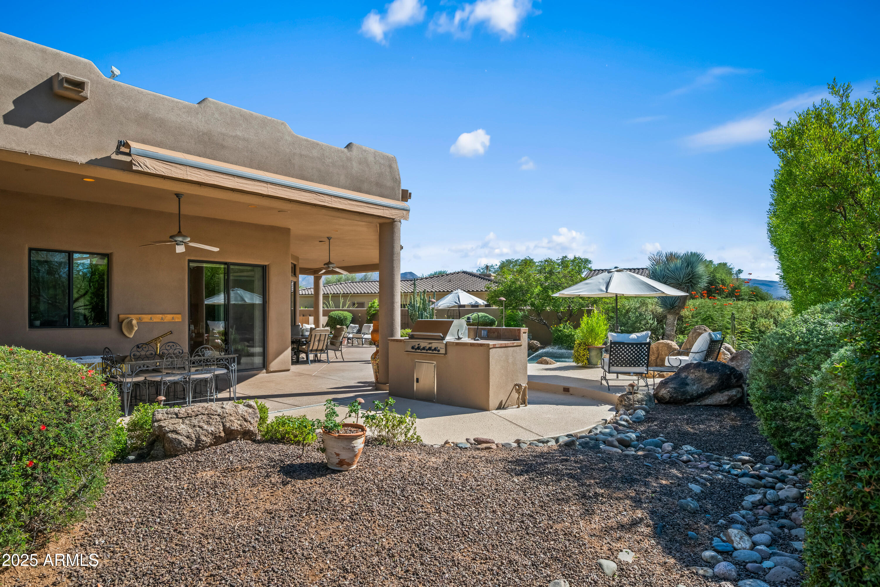 19007 East Lazo Court Rio Verde, AZ 85263 - Photo 42 of 58 a front view of a house with garden and patio