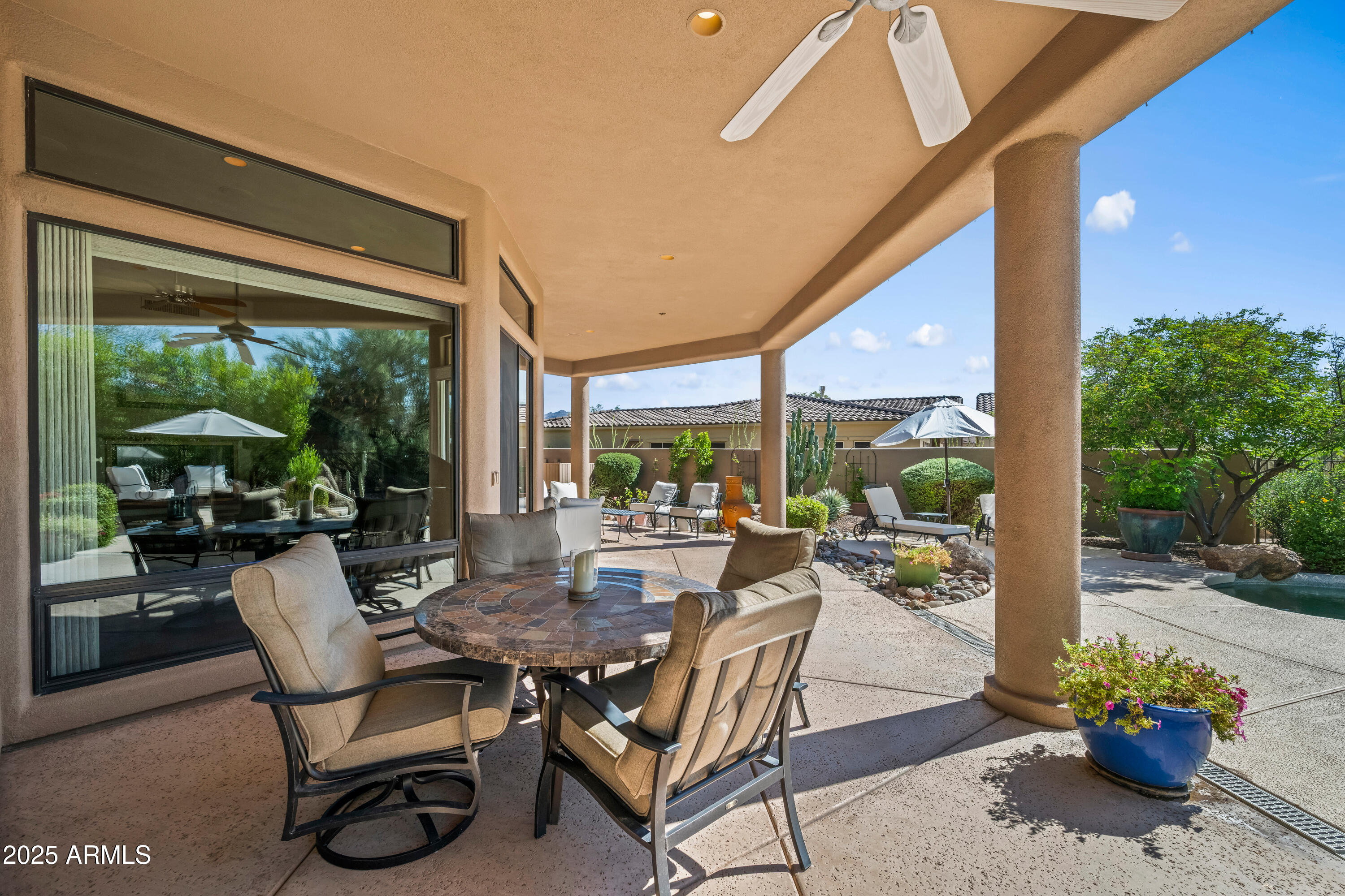19007 East Lazo Court Rio Verde, AZ 85263 - Photo 46 of 58 a outdoor space with patio the couches and a dining table with garden view
