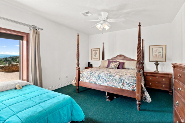 5615 East Eight Mile Gap Road Kanab, UT 84741 - Photo 56 of 81 Carpeted bedroom with ceiling fan and baseboards