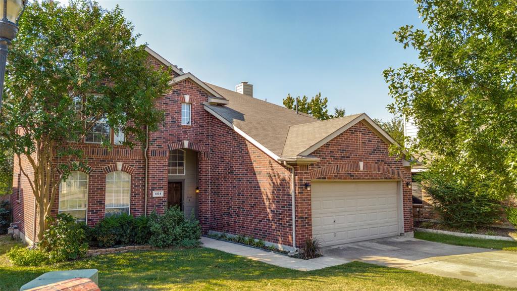 a front view of a house with a yard garage and outdoor seating