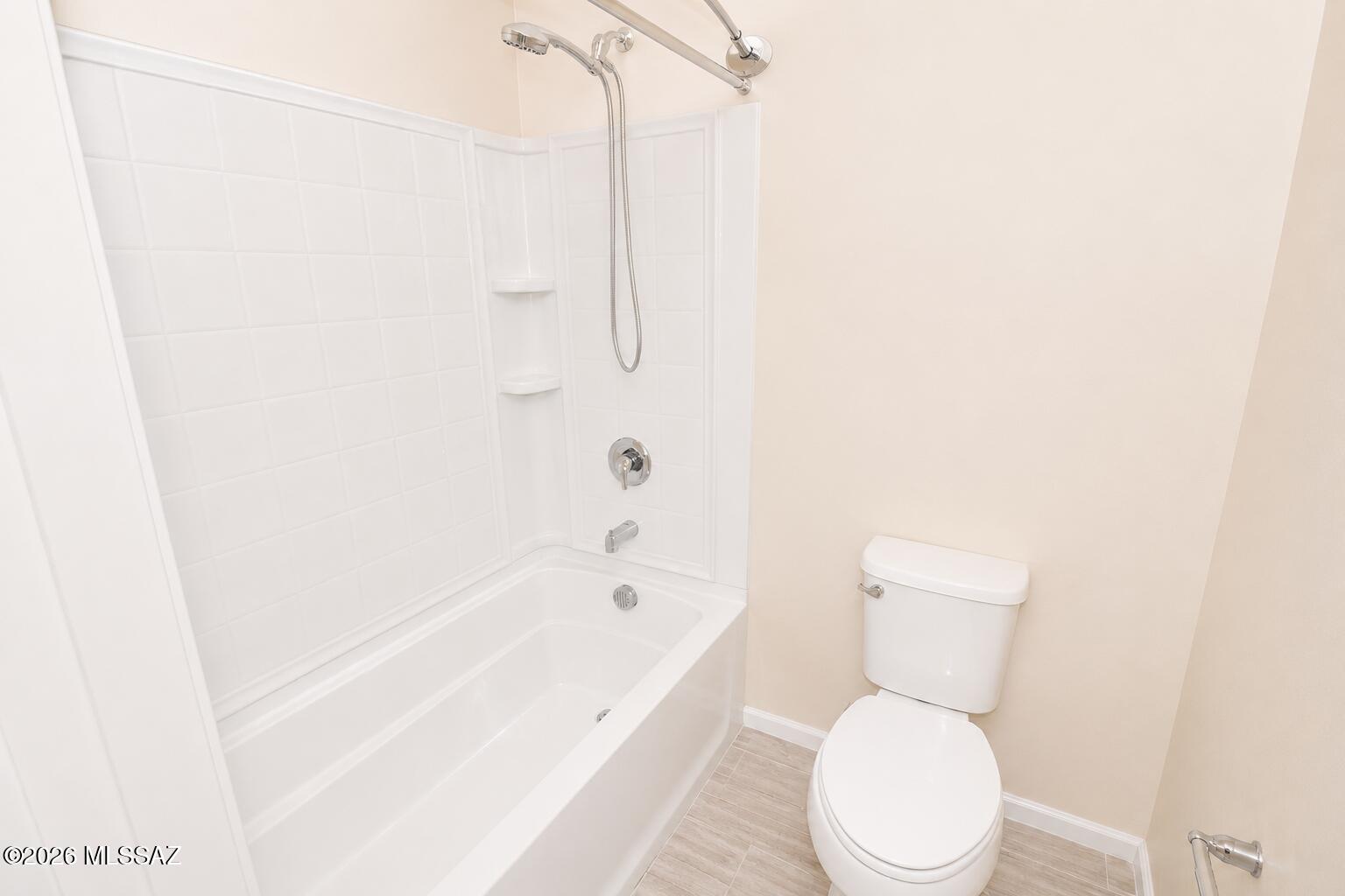 11484 East Desert Raptor Loop Tucson, AZ 85747 - Photo 9 of 28 a white toilet sitting next to a bath tub