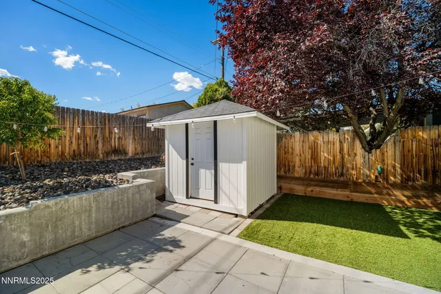 a view of a house with backyard and sitting area
