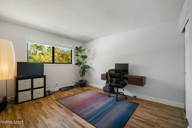 a workspace with furniture window and wooden floor