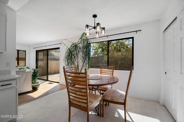 a dining room with furniture window and wooden floor