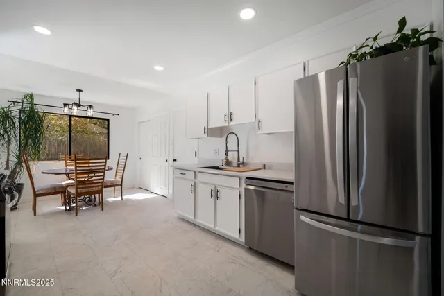 a kitchen with stainless steel appliances a refrigerator and a stove top oven