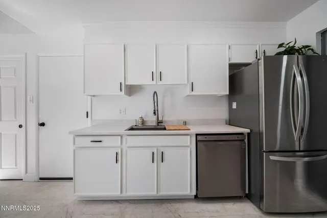 a kitchen with stainless steel appliances a refrigerator and a sink