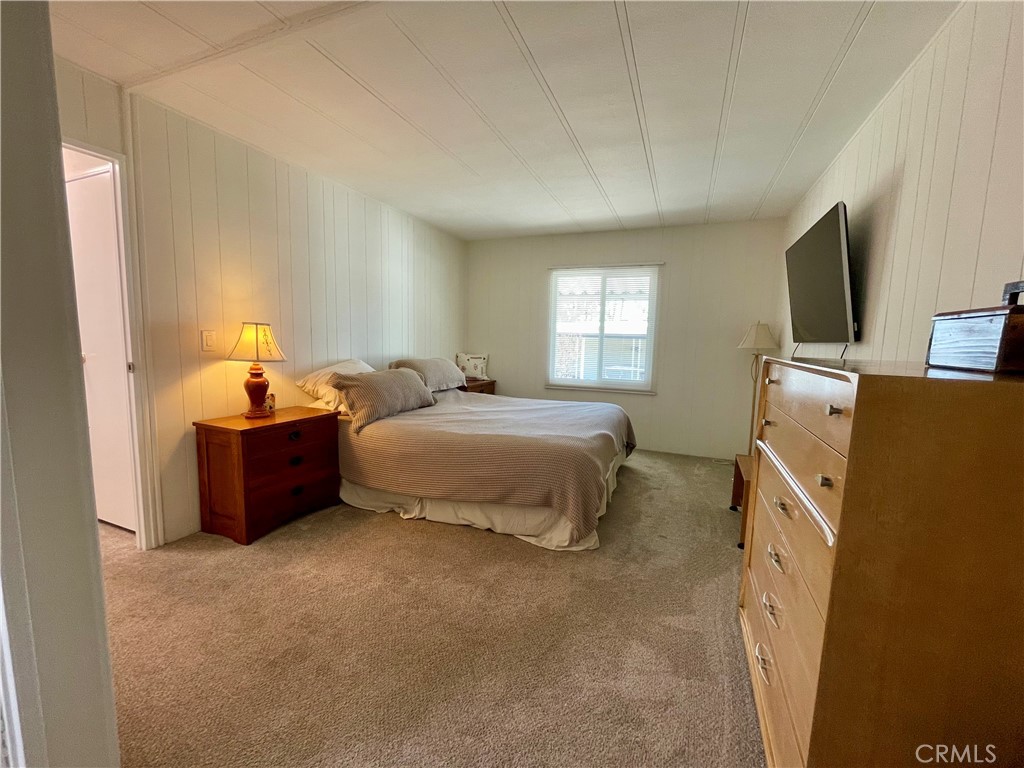 31130 South General Kearny Road, Unit 145 Temecula, CA 92591 - Photo 15 of 27 a bed room with a bed and a television