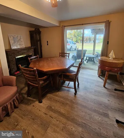 a living room with furniture a large window and a table