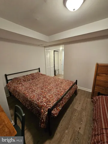 a kitchen with stainless steel appliances granite countertop a stove a sink dishwasher and a refrigerator with wooden floor