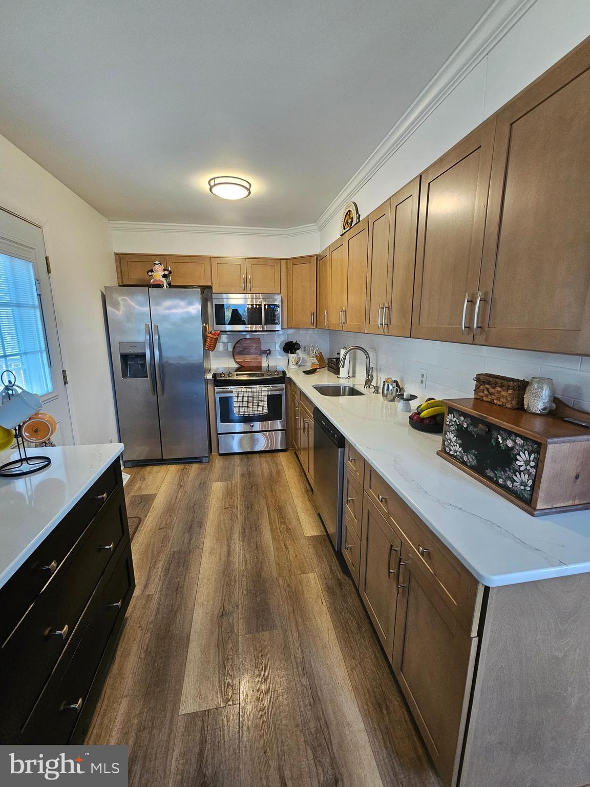 82 Basin Road Earleville, MD 21919 - Photo 16 of 46 a kitchen with stainless steel appliances granite countertop a stove a sink dishwasher and a refrigerator with wooden floor