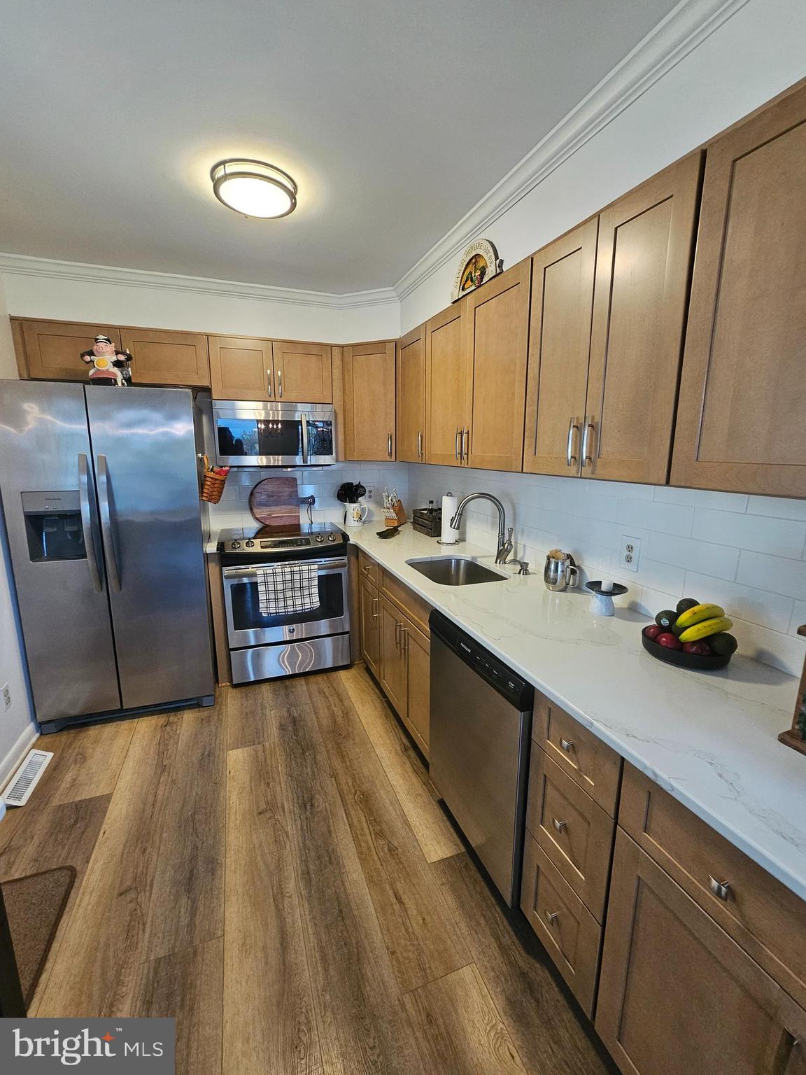 82 Basin Road Earleville, MD 21919 - Photo 17 of 46 a kitchen with granite countertop a sink and wooden cabinets