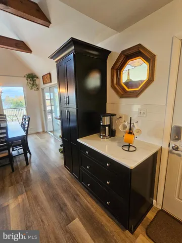 a living room with couches bookshelf and a large window