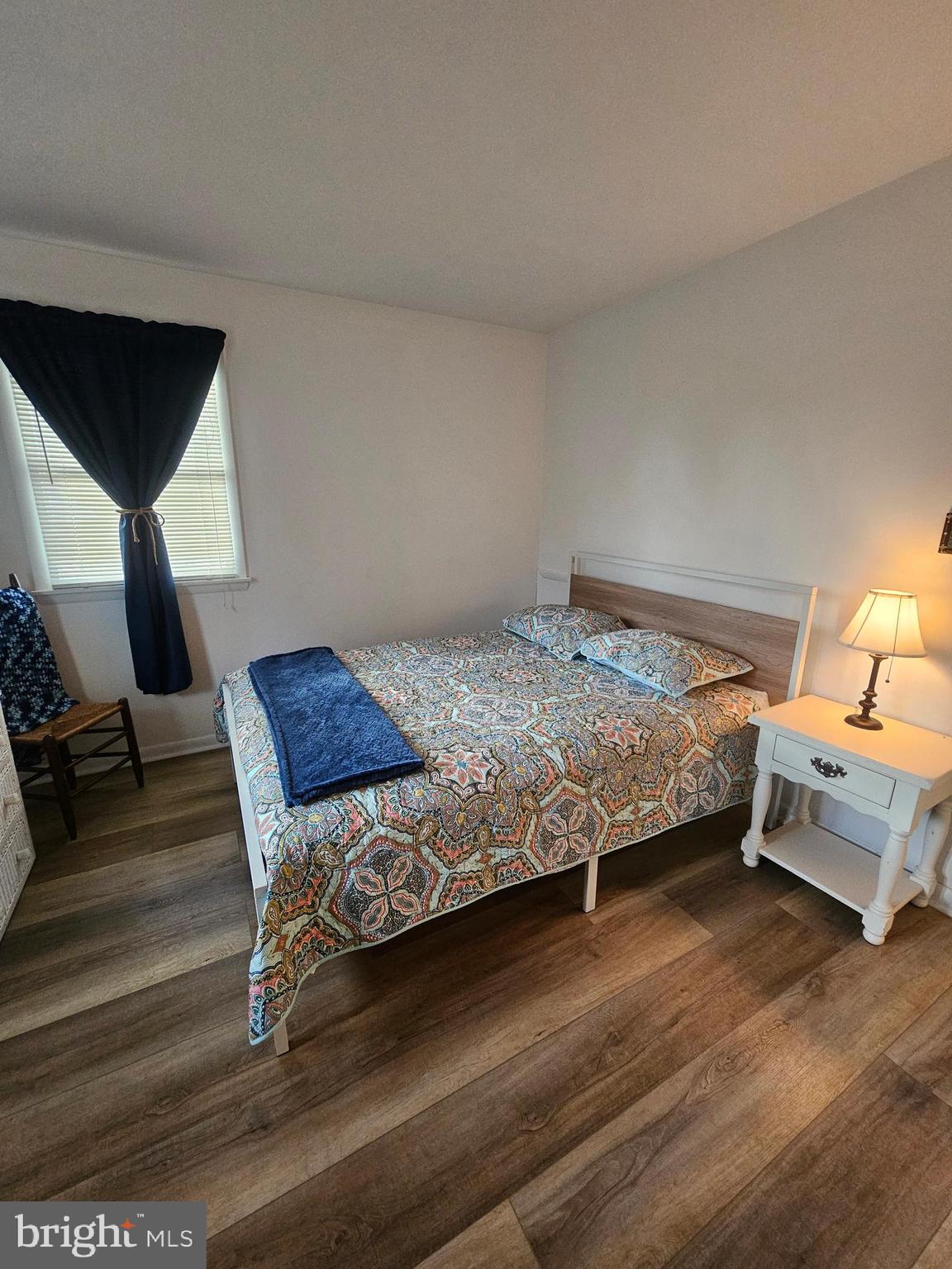 82 Basin Road Earleville, MD 21919 - Photo 29 of 46 a bedroom with a bed and wooden floor