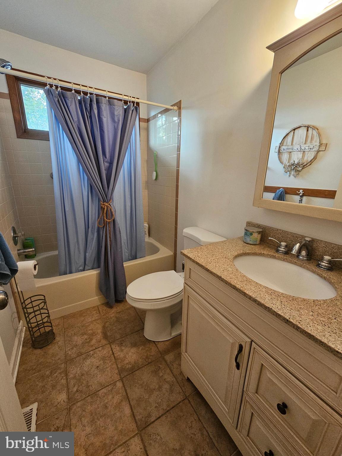 82 Basin Road Earleville, MD 21919 - Photo 32 of 46 a bathroom with a granite countertop sink a toilet and a mirror