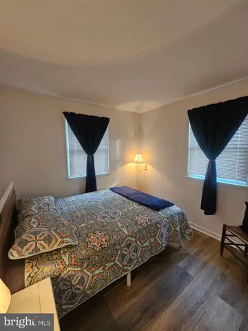 a bedroom with a bed a desk and chair