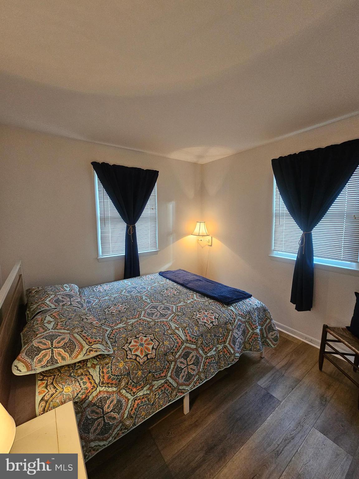 82 Basin Road Earleville, MD 21919 - Photo 34 of 46 a bedroom with a bed and a lamp