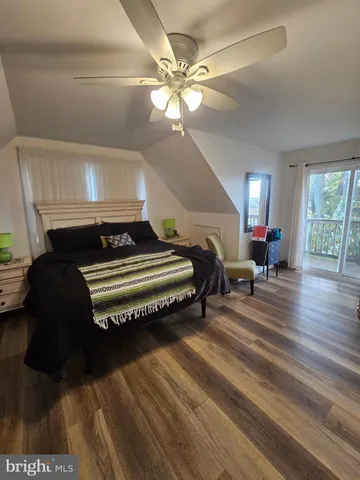 a bedroom with a bed lamp and a dresser