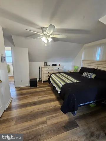 a spacious bedroom with a bed and a chandelier