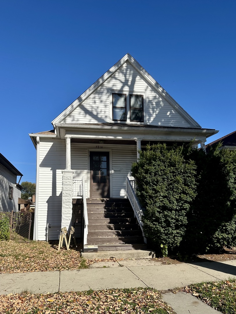 a view of a house with a wooden fence