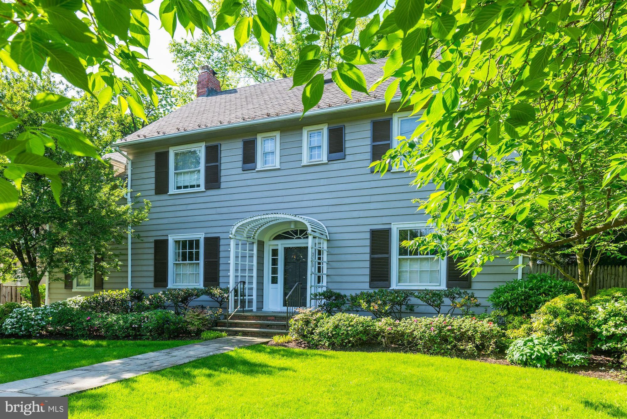 3720 Bradley Lane Chevy Chase, MD 20815 - Photo 2 of 29 a front view of a house with a yard and trees