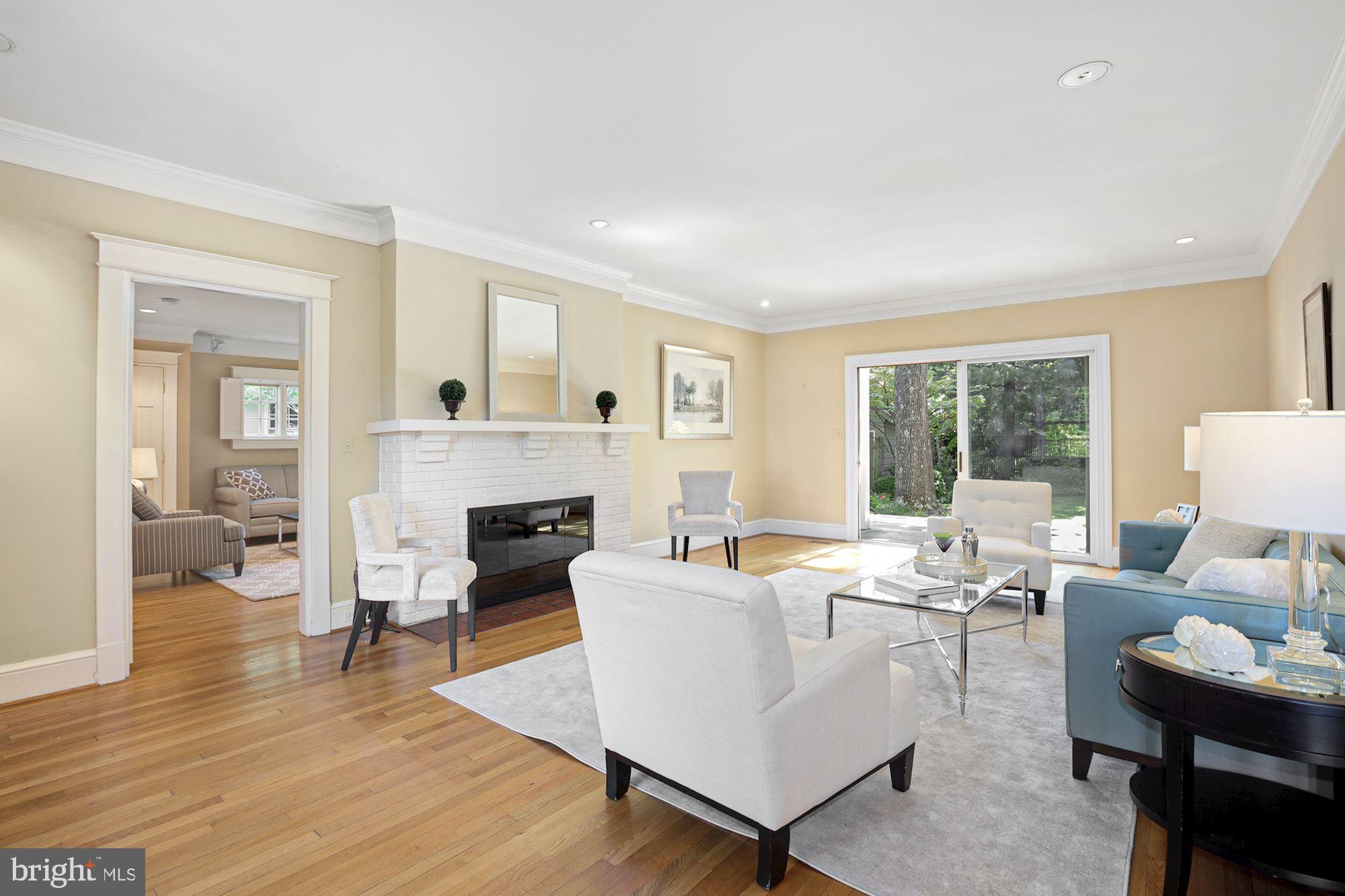 3720 Bradley Lane Chevy Chase, MD 20815 - Photo 12 of 29 a living room with furniture a fireplace and a large window