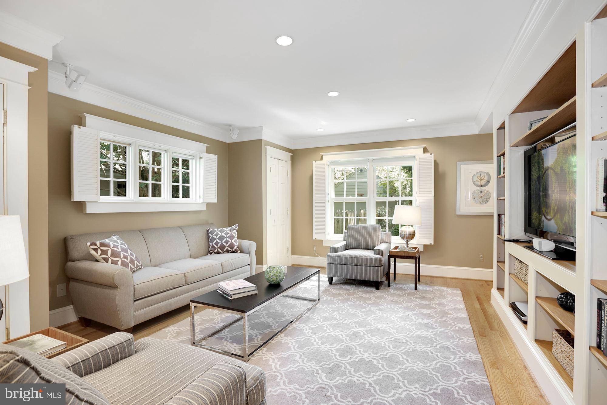 3720 Bradley Lane Chevy Chase, MD 20815 - Photo 14 of 29 a living room with furniture a flat screen tv and a window
